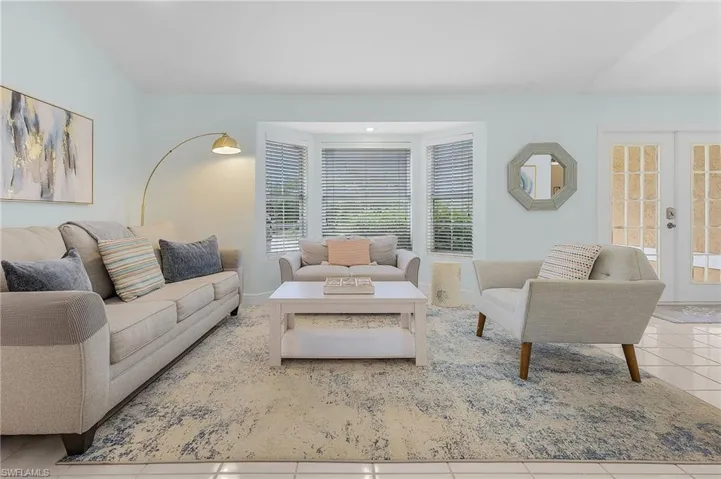 Living room featuring light tile patterned floors and french doors