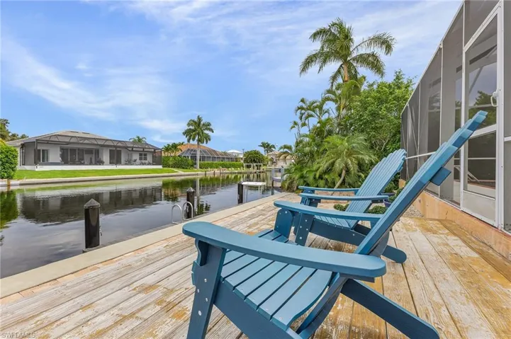 Dock area featuring glass enclosure and a water view