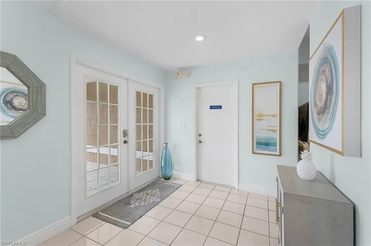Doorway featuring light tile patterned floors and french doors