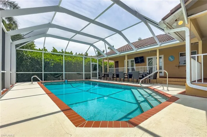 View of pool with a lanai and a patio area