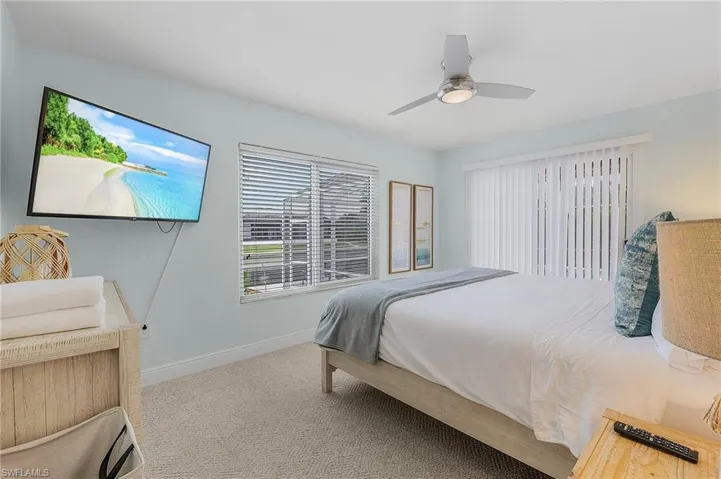 Bedroom featuring light carpet and ceiling fan