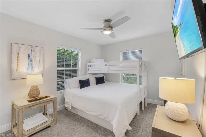 Bedroom with ceiling fan and carpet
