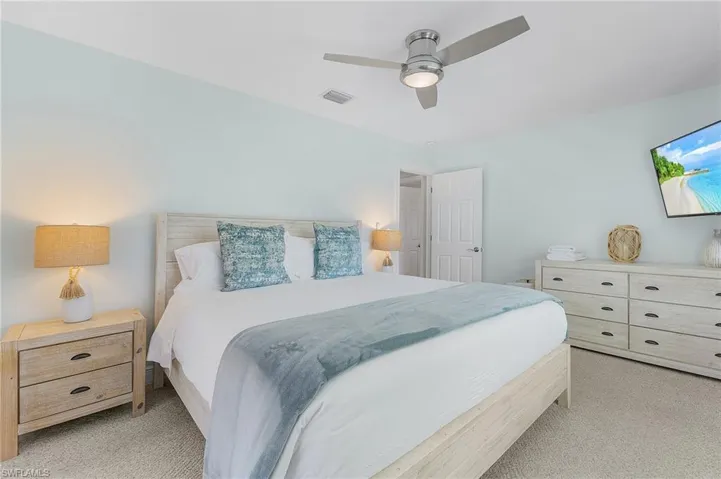 Carpeted bedroom featuring ceiling fan