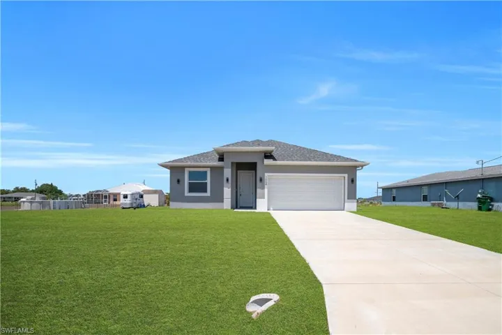 Contemporary single-story residence featuring a gray exterior with white trim