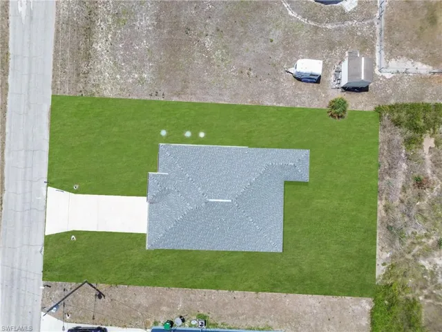 Aerial perspective showcasing a single-story residence with a gray shingle roof