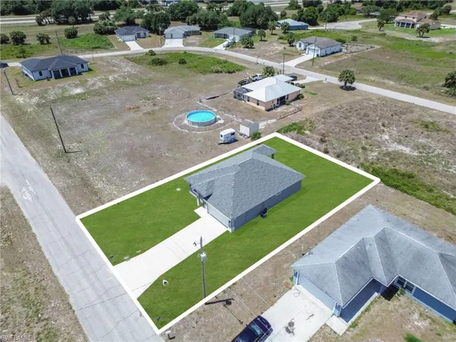 Single-story residence with a gray shingle roof and a concrete driveway