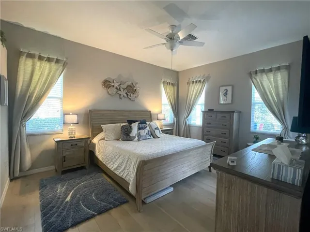 Master Bedroom with wood finished floors and a ceiling fan
