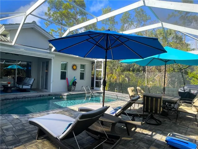 Outdoor pool featuring a patio, a lanai, area for grilling, outdoor dining area, and a sunroom-pool surface was completely redone recently as well as pool deck