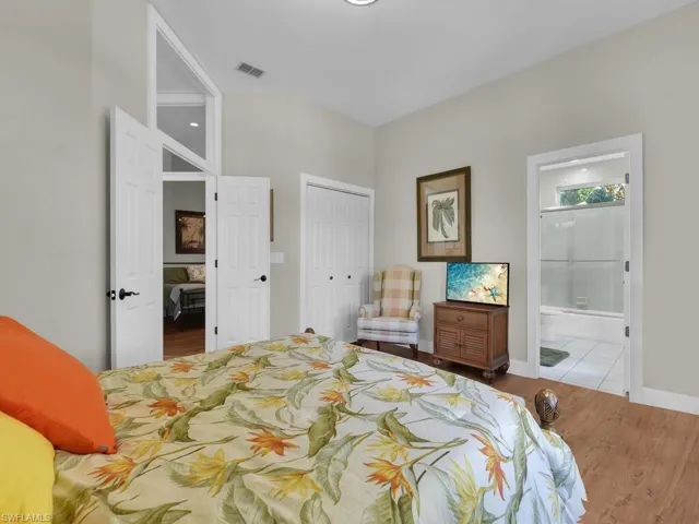 Full bath with vanity, enclosed tub / shower combo, and tile patterned flooring