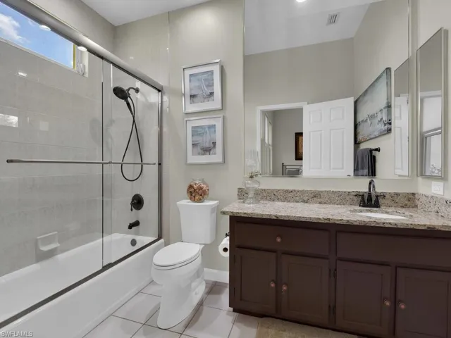 Bathroom featuring a shower stall, a jetted tub, and tile patterned flooring