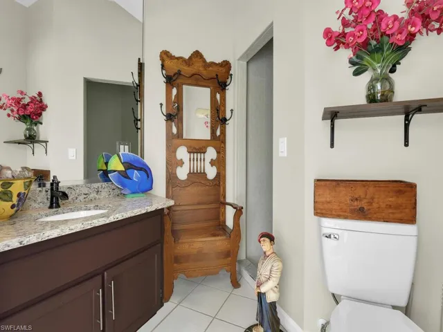 Full bath featuring plenty of natural light, vanity, combined bath / shower with glass door, and tile patterned flooring