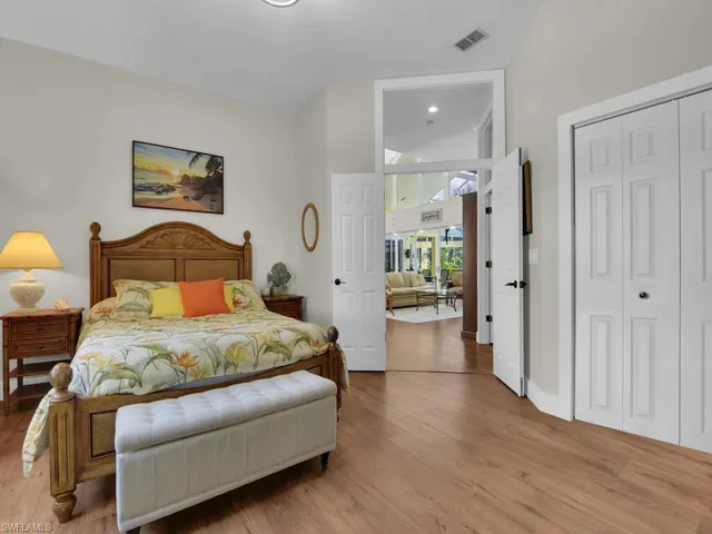 Bedroom with wood finished floors and a chandelier