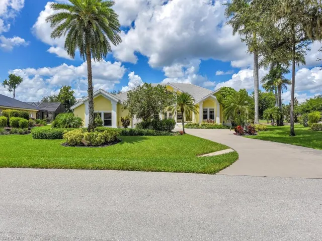 View of green lawn featuring an attached garage