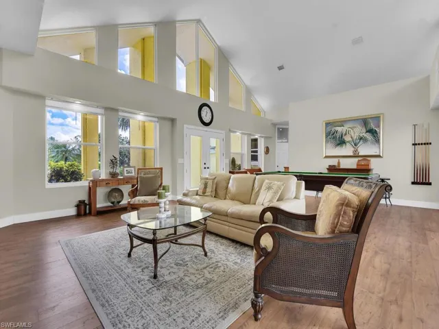 Playroom with hardwood / wood-style flooring and high vaulted ceiling