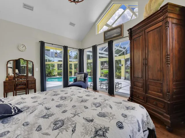 Living room featuring a chandelier, plenty of natural light, high vaulted ceiling, and wood finished floors