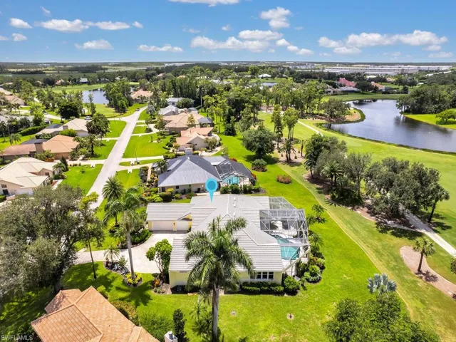 Aerial view of residential area with a large body of water and a local golf course