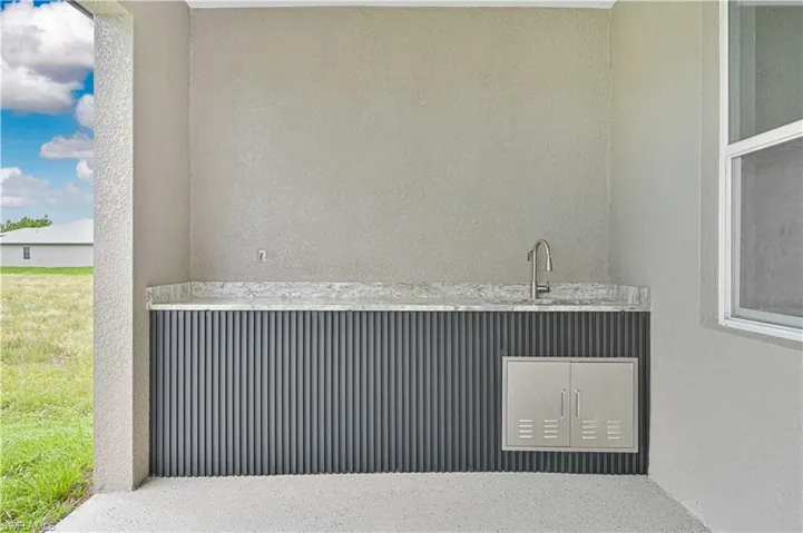Detailed view of stucco siding and a sink