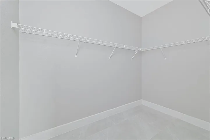 Walk in closet featuring light tile patterned floors