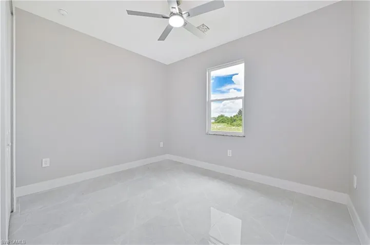 Empty room with baseboards and ceiling fan