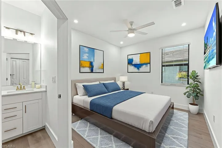 Bedroom featuring light wood finished floors, a ceiling fan, and recessed lighting