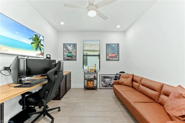 Office featuring wood tiled floors, ceiling fan, and recessed lighting