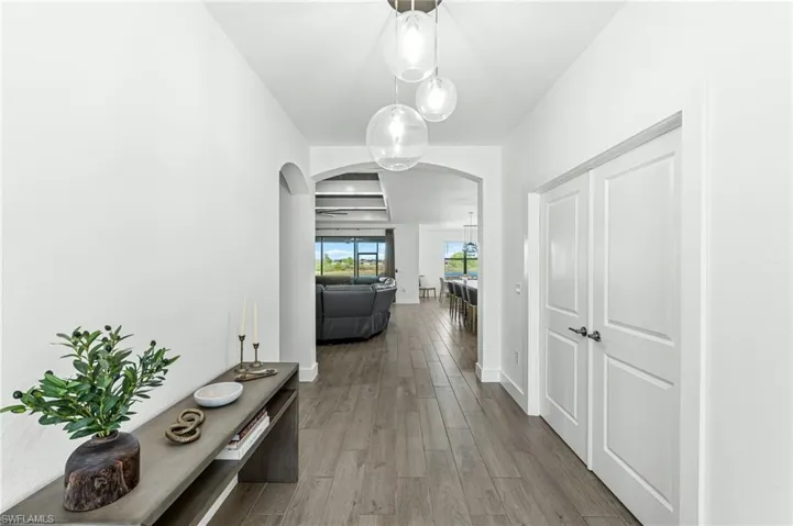 Hall with wood finished floors and arched walkways