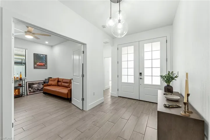 Foyer featuring wood tiled floors and french doors