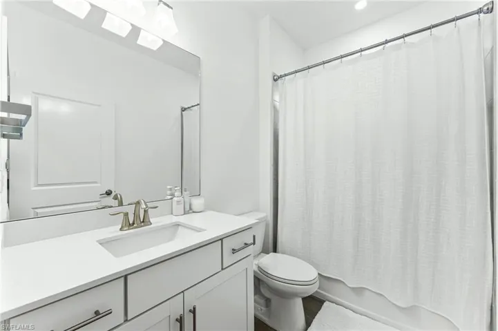 Bathroom featuring shower / bath combo and vanity