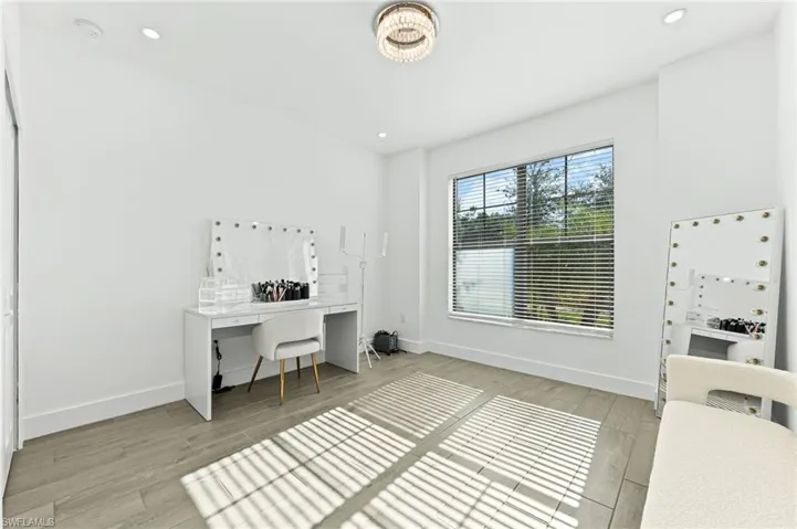 Office featuring light wood-type flooring and recessed lighting