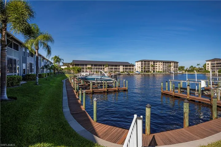Dock area with a yard and a water view