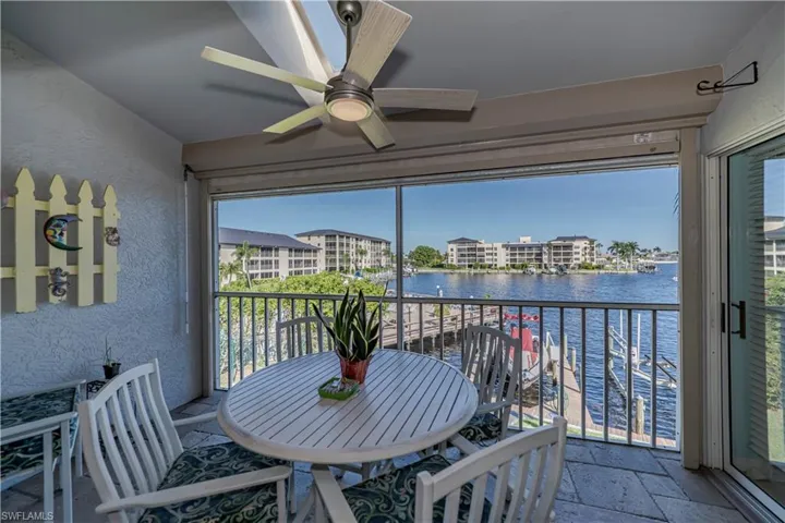 Sunroom / solarium with a water view and ceiling fan
