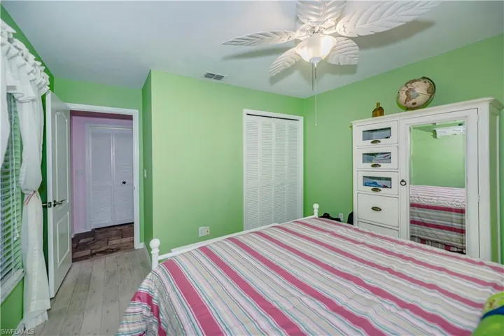 Bedroom featuring hardwood / wood-style floors, a closet, and ceiling fan