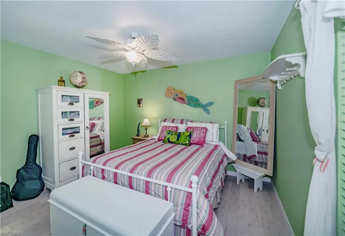 Bedroom with ceiling fan and hardwood / wood-style flooring