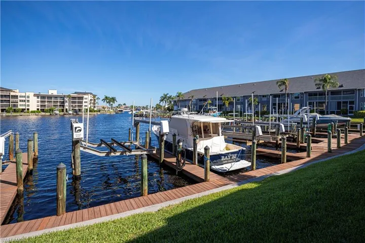 Dock area featuring a water view and a yard