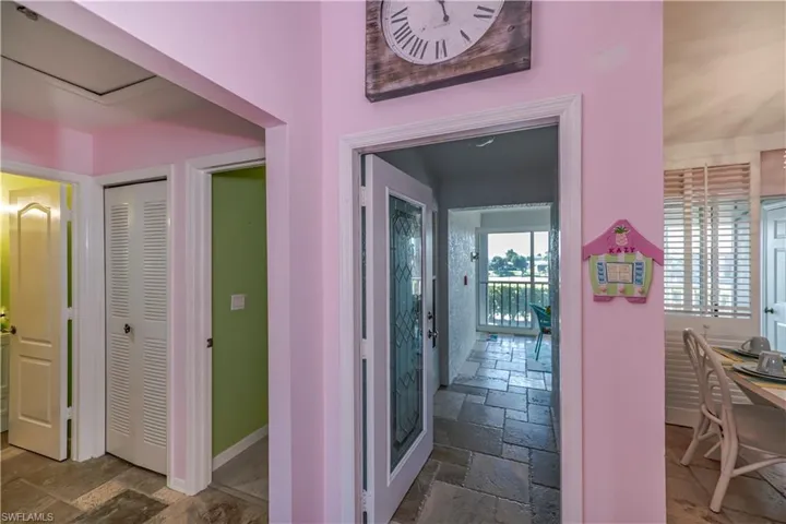 Hallway with dark tile flooring