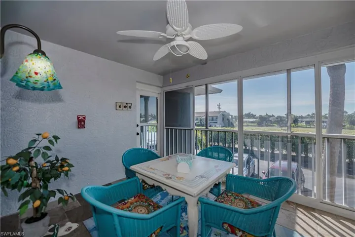 Sunroom featuring ceiling fan