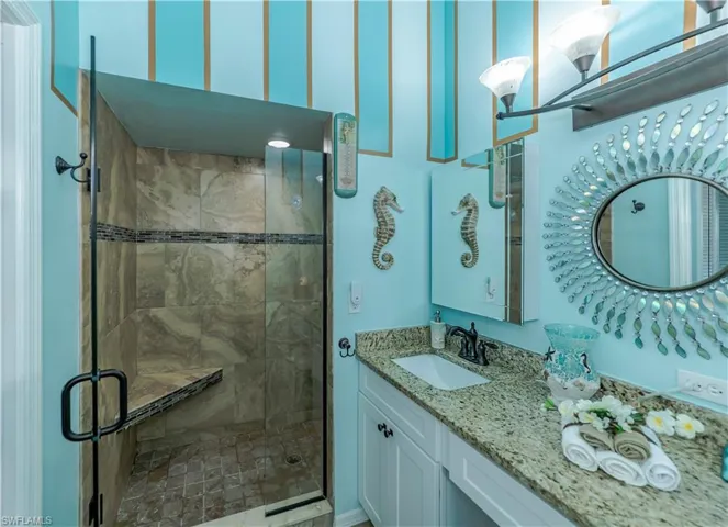 Bathroom featuring walk in shower and vanity