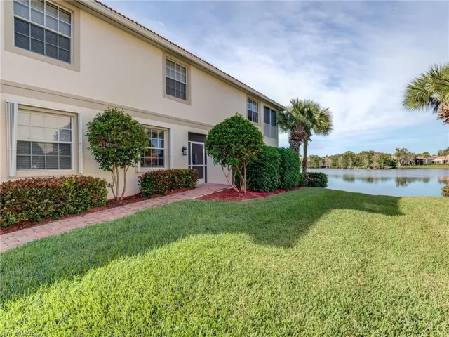 Entrance with a lake view to greet you and your guests.  Note the accordion shutters on the windows.
