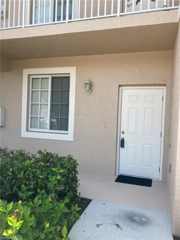 Property entrance featuring stucco siding
