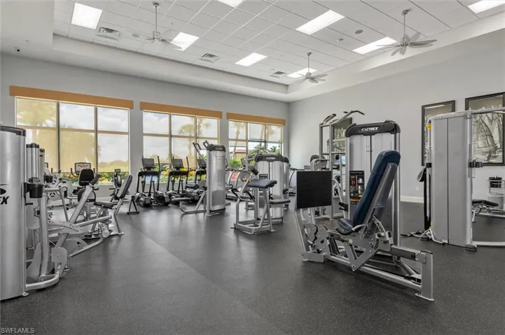 Spacious Community fitness center featuring expansive windows, commercial-grade exercise equipment