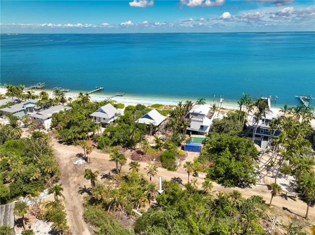 Aerial view featuring a view of the beach and a water view