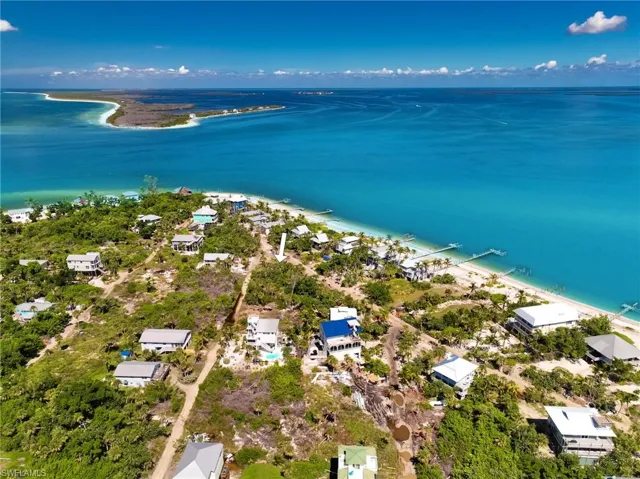 Aerial view featuring a water view and a view of the beach
