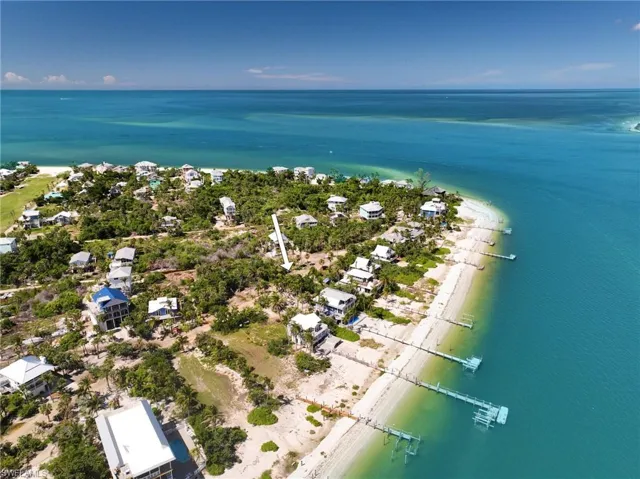 Aerial view featuring a water view and a beach view