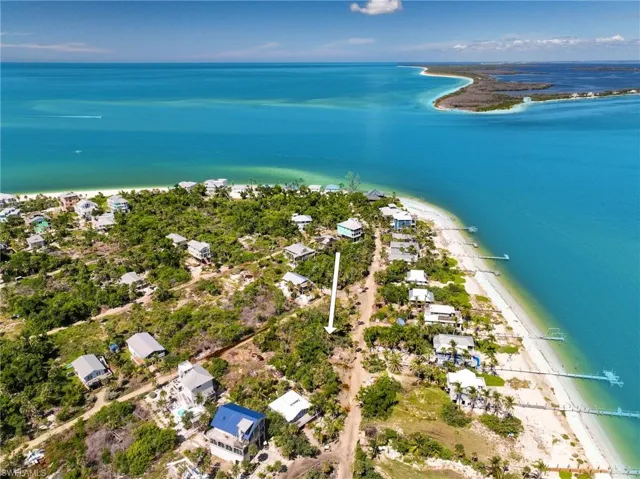 Drone / aerial view with a view of the beach and a water view