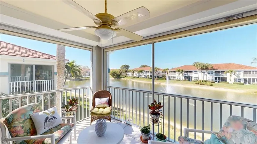 Community pool featuring a patio area and glass enclosure