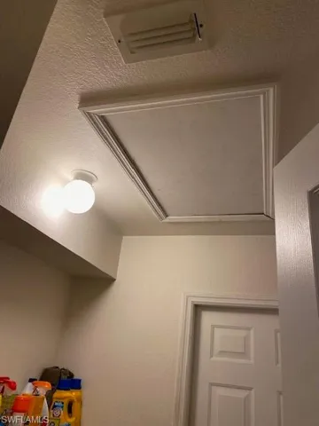 Attic access in laundry room.  Doorway leads to two car garage