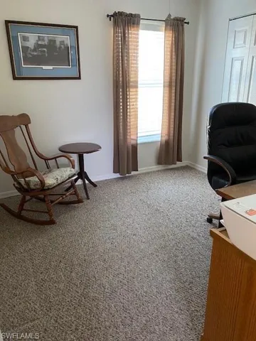 Second bedroom with walk-in closet utilized as husband's office/den