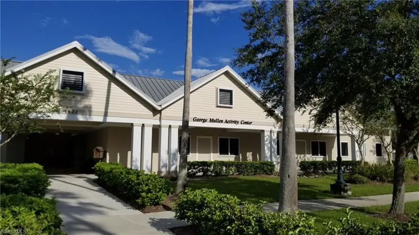 View of front of home with a carport and a front lawn