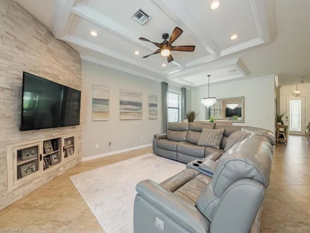 Living area with ornamental molding, beam ceiling, coffered ceiling, and visible vents