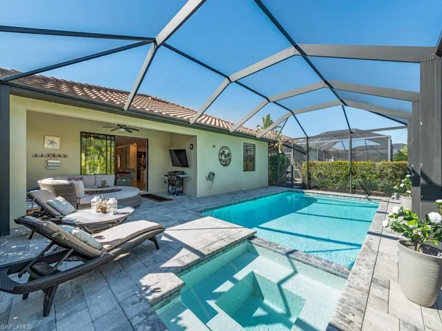 View of pool featuring ceiling fan, a patio, outdoor lounge area, area for grilling, and a pool with connected hot tub